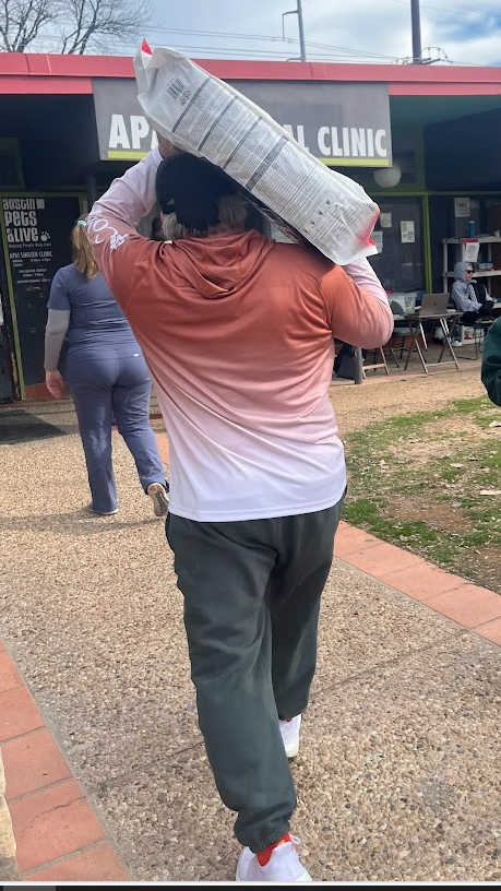 Mr. Craig Carlton carrying bags for Austin Pets Alive.